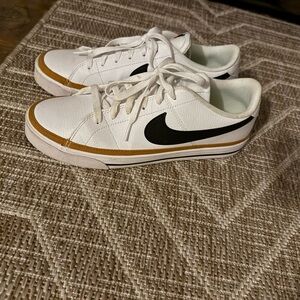 Nike White Sneakers with Black Swoosh and Gold Trim